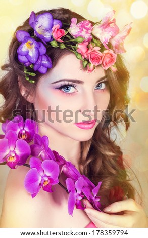 beautiful girl with orchids and freesias in hair