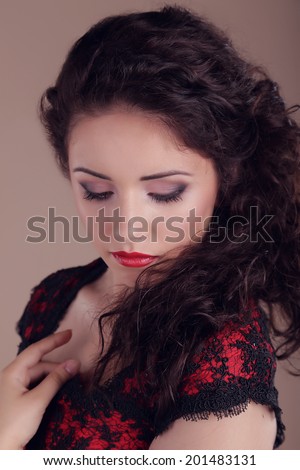 Closeup portrait of beautiful sexy brunette with red lips, hairstyle. The girl looks like Carmen