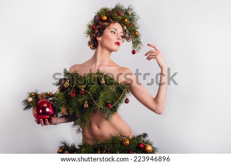 Christmas Woman. Beautiful New Year and Christmas Tree. Beautiful girl with a fantastic hair and makeup
