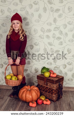 A child with a vegetable. Happy little girl with basket of vegetables, Gardening - lovely girl with ecological harvests. Lovely kid eating healthy food. studio.