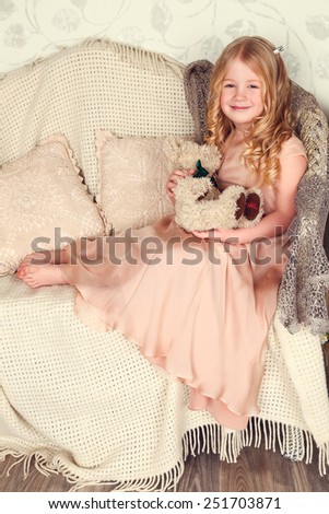 fashion interior photo of beautiful child. Girl in a golden dress