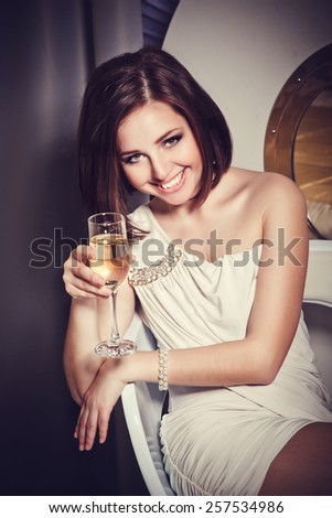 Beautiful young sexy woman in luxurious interior. Luxury lifestyle. Joy. Elation. Vintage vogue style. pretty young woman in hotel. Happy smiling/ luxurious brunete rich lady at retro hotel