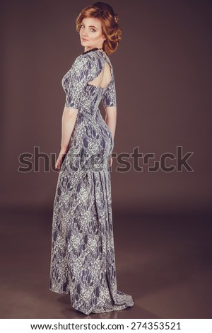 Studio photo of a young woman in retro style, evening dress and jewelry,