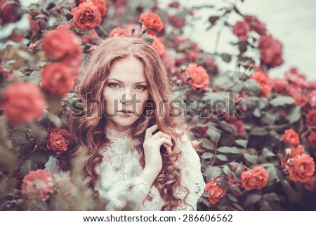 Portrait of young woman in the spring time. Almond flowers blossoms. Girl dressed in white like a bride. rose Garden