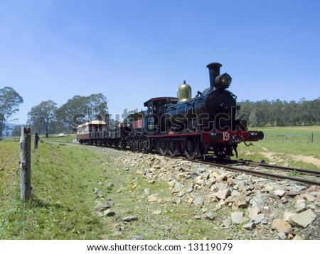 steam train traveling through a green field