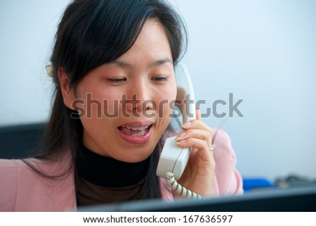 pretty asian manager woman talking by phone