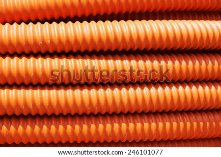 Orange industrial plastic pipe background