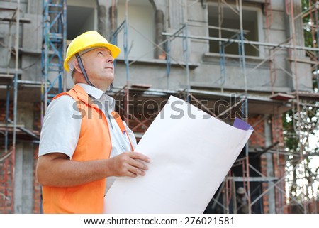 Builder in helmet with a drawing plan photo