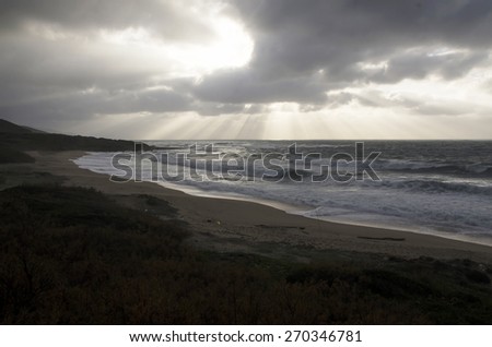 landscape of rough sea with cloudy sky by storm and burst of light as background
