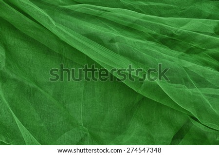 Close-up of plastic net. Artistic texture or background. Abstract plastic net texture. Background in dark green.