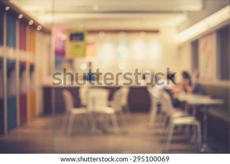 De focused/Blur image of a restaurant with a coupe of lovers in it. Blurred people in restaurant. Blurred background of lovers sitting in the restaurant. Retro effect.