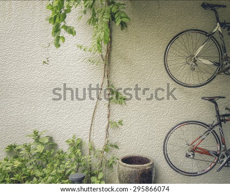 Digital oil painting of two bicycles hanging on the wall. Plants climbing along the wall. A water vat and lamp on the ground. Oil painting effect.