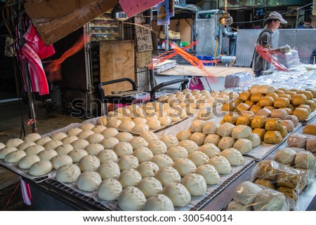New Taipei City/Taiwan - 15 March 2015: steamed stuffed bun and steamed bread sold at Taiwanese traditional market. Simple electric fans are set up above the stand to chase away flies.