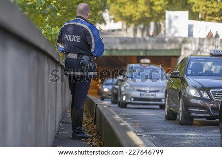PARIS, FRANCE - OCTOBER 31, 2014 :French policeman controls speed with a mobile radar Pro laser 4