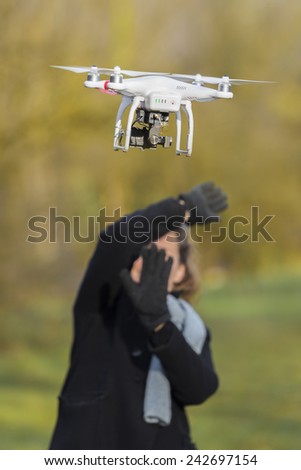 VERSAILLES, FRANCE - JANuary 03, 2014 - Drone scares woman flying around her