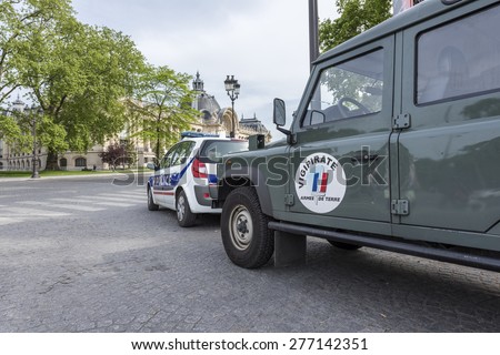 PARIS, FRANCE - MAY 12, 2015 : French army car and Police car parked in the street to patrol for Plan Vigipirate (France\'s national security alert system) against possible terrorist attacks.