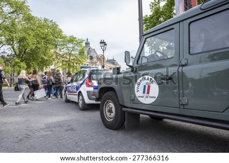 PARIS, FRANCE - MAY 12, 2015 : French army car and Police car parked in the street to patrol for Plan Vigipirate (France\'s national security alert system) against possible terrorist attacks.