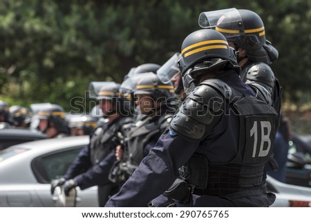 PARIS, FRANCE - JUNE  25, 2015 :  French police (riot squad) try to control the protest of the taxi drivers against the service Ubber Pop at the Porte Maillot.