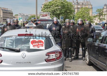 PARIS, FRANCE - JUNE  25, 2015 :  French police (riot squad) try to control the protest of the taxis against the service Ubber Pop at the Porte Maillot.