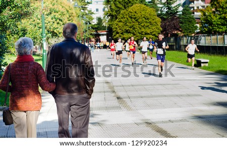 PONTEVEDRA, OCTOBER 12: An elderly couple watching the runners  of the Half Marathon held in the streets of the city of Pontevedra, on October 12, 2012.