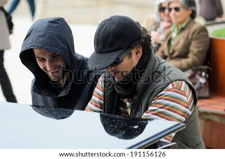 BILBAO, SPAIN - APRIL 4, 2014: Two men in  plays a grand piano during music initiative \