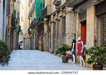 GIRONA, SPAIN - APRIL 9, 2014: Mannequins in the door of a clothing store in one of the streets of the historic town of Girona.