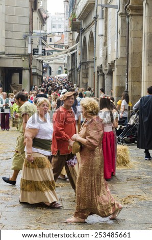 PONTEVEDRA, SPAIN - SEPTEMBER 6, 2014: Crowd of people dressed in period costume, in medieval festival held each year in the historical district of the city.