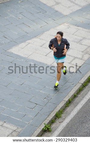 PONTEVEDRA, SPAIN - OCTOBER 19, 2014: A woman practices running in one of the banks of the river which crosses the city.