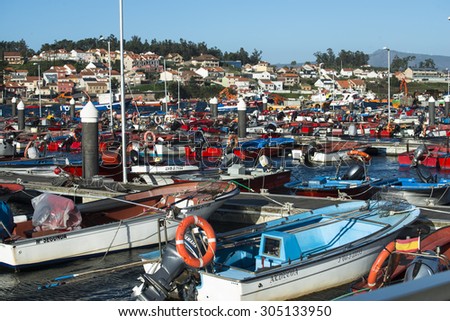 ILLA DE AROUSA, SPAIN - NOVEMBER 30, 2014: Detail of fishing boats anchored in the harbor of this beautiful island in the Ria de Arousa in Galicia.