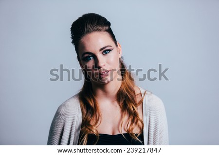 Studio Portrait of Young Attractive Woman straight on shot head tilted slight smile