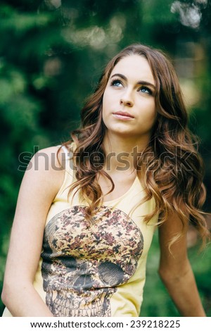 Portrait of Young Attractive Woman with beautiful blue eyes looking up with skull t-shirt