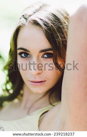 Portrait of Young Attractive Woman Close Up with arm near head