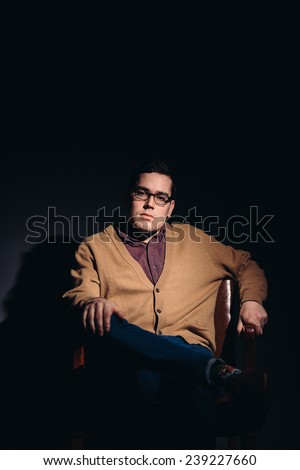 dramatic light young man in 1950's clothes thinking about mad men