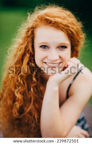 Attractive Young Female Redhead, smiling, hand under chin, vertical, variation close up