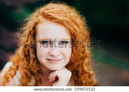 Attractive Young Female Redhead, slight smile, hand on chin
