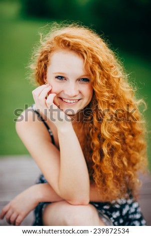 Attractive Young Female Redhead, smiling, hand under chin, vertical, variation