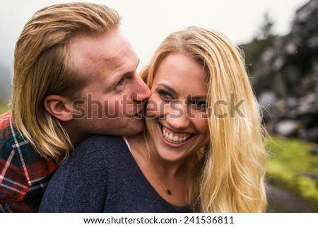 Attractive Young Blond Couple in the Pacific Northwest guy kissing girl on cheek