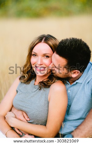 Beautiful Couple in Wheat Field Guy Kissing Cheek