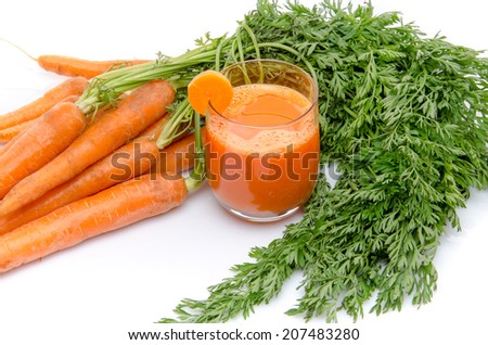 Composition with a glass of carrot juice and fresh carrots, isolated on white