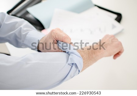 Motivated businessman rolling up his sleeves