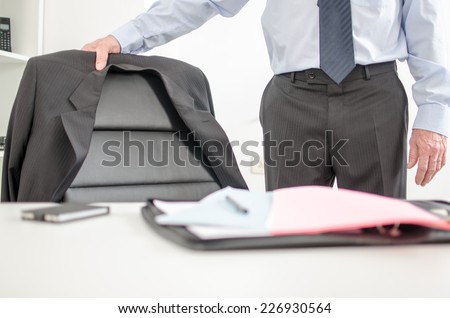 Businessman about to sit at his desk