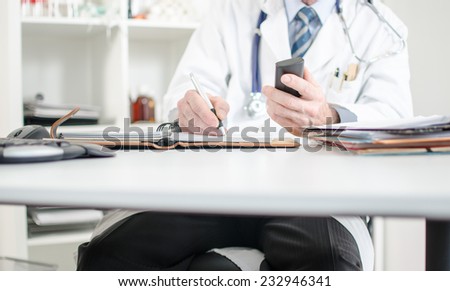 Doctor taking an appointment at his office