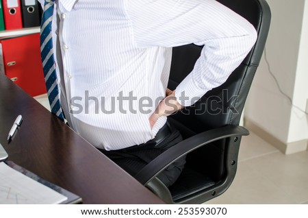Businessman with back pain at office