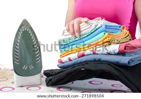 Woman holding a pile of ironed linen
