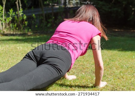 Woman doing physical exercises outdoors