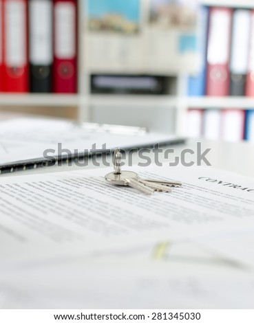 Keys on a real estate contract in real estate agency