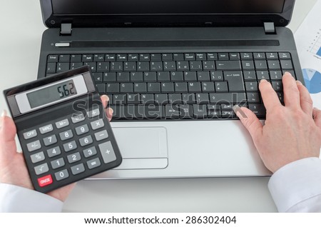 Accountant woman working on financial results at the office