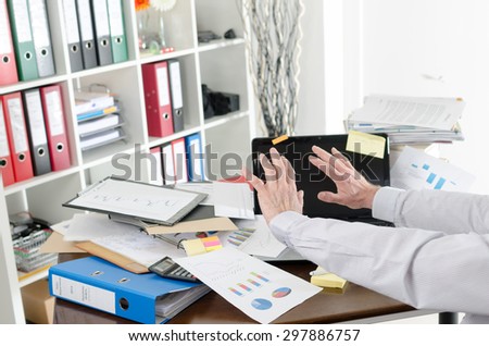 Businessman refusing to see his cluttered desk