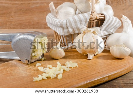 Fresh crushed garlic on wooden background