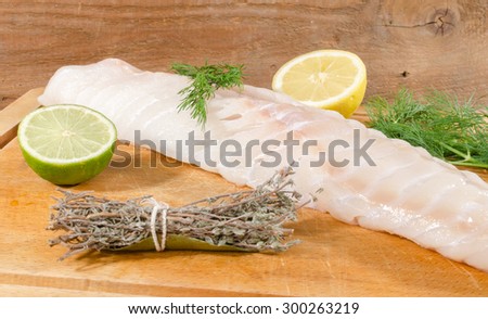 Cod fillet on wooden board